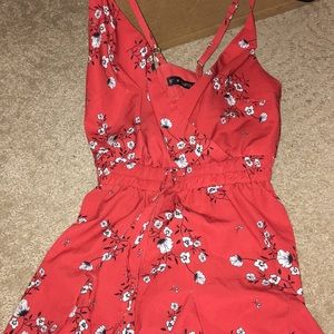 Red romper with a flower design